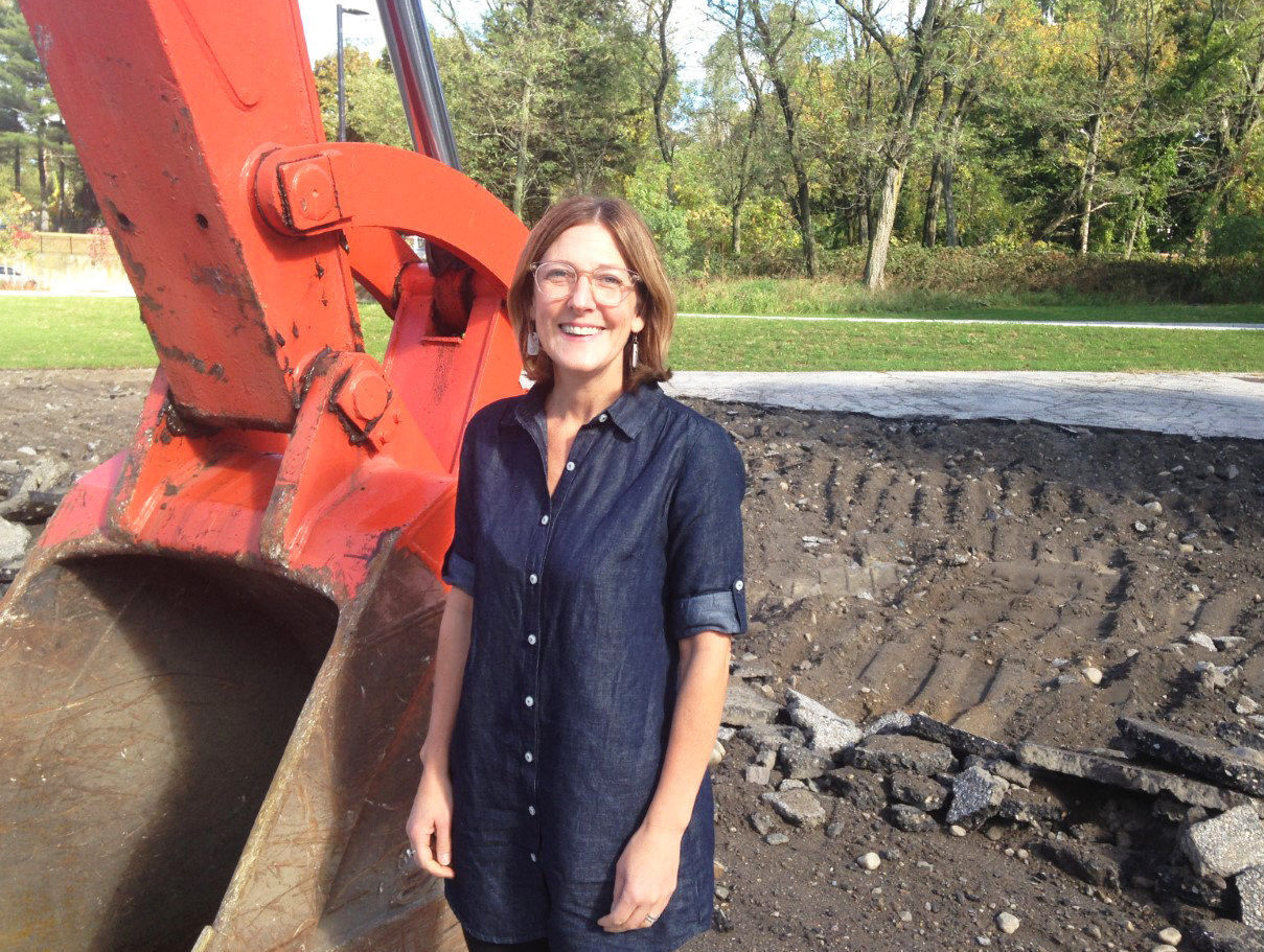 Jennifer Hawkins, executive director of ONE Neighborhood Builders, at the construction site in Olneyville where five new small homes will be built, ready for occupancy next fall.